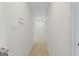 Bright hallway with tile flooring and neutral walls, leading to various rooms at 128 Southern Magnolia Ln, Rex, GA 30273