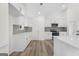 Stylish kitchen with white cabinets, stone countertops, stainless appliances, and modern backsplash at 128 Southern Magnolia Ln, Rex, GA 30273
