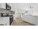 Beautiful kitchen with white cabinetry, modern appliances, and an open layout to the living space at 128 Southern Magnolia Ln, Rex, GA 30273