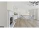 Open living room featuring a fireplace, hardwood floors, and access to kitchen and staircase at 128 Southern Magnolia Ln, Rex, GA 30273