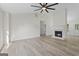 Bright living room featuring a ceiling fan, hardwood floors, and a cozy fireplace at 128 Southern Magnolia Ln, Rex, GA 30273