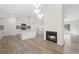 Open-concept living area connects a modern kitchen and living room with a cozy fireplace at 128 Southern Magnolia Ln, Rex, GA 30273