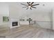 Open-concept living room with fireplace, hardwood floors, and access to kitchen and staircase at 128 Southern Magnolia Ln, Rex, GA 30273