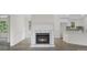 Cozy living room featuring a fireplace, hardwood floors, and a modern kitchen island at 128 Southern Magnolia Ln, Rex, GA 30273