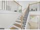 Staircase featuring natural wood treads, white risers, and a black wrought iron railing at 128 Southern Magnolia Ln, Rex, GA 30273