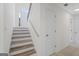 Bright foyer features stairs with wooden treads, complementing the neutral tones and natural light at 128 Southern Magnolia Ln, Rex, GA 30273