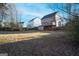 Large backyard with lawn and wood fence surrounding the perimeter at 860 Sweet Mill Ln, Lawrenceville, GA 30045