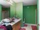 Bathroom features vanity, mirror, and shower with green painted walls at 860 Sweet Mill Ln, Lawrenceville, GA 30045