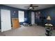 A bedroom with dark blue walls, ceiling fan and cluttered appearance at 860 Sweet Mill Ln, Lawrenceville, GA 30045