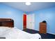 Bedroom with bright blue walls, dark blue carpet and closet access at 860 Sweet Mill Ln, Lawrenceville, GA 30045