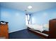 Bedroom with bright blue walls, dark blue carpet and natural light from a window at 860 Sweet Mill Ln, Lawrenceville, GA 30045