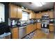 Functional kitchen with wooden cabinetry, granite countertops, and stainless steel appliances at 860 Sweet Mill Ln, Lawrenceville, GA 30045