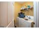 Small laundry room with washer, dryer and shelf full of detergent at 860 Sweet Mill Ln, Lawrenceville, GA 30045