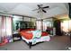 Spacious main bedroom featuring a trey ceiling, ceiling fan, mirrorred closet doors and ensuite bathroom access at 860 Sweet Mill Ln, Lawrenceville, GA 30045