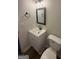Bathroom featuring a modern single sink vanity, toilet, and updated fixtures at 60 Doe Run Dr, Sharpsburg, GA 30277