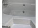 Bright white bathtub with chrome hardware and a minimalistic design at 60 Doe Run Dr, Sharpsburg, GA 30277