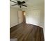 Spacious bedroom with new floors, a ceiling fan, closet, and an entry door at 60 Doe Run Dr, Sharpsburg, GA 30277