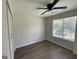 Bedroom boasts hardwood floors, a ceiling fan, a window, and closet space at 60 Doe Run Dr, Sharpsburg, GA 30277
