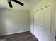 This bedroom has a ceiling fan and closet for storage solutions at 60 Doe Run Dr, Sharpsburg, GA 30277