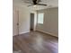 This bedroom features wood floors, ceiling fan and a closet at 60 Doe Run Dr, Sharpsburg, GA 30277