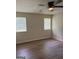 A bedroom with two windows, wood-look floors, and neutral paint at 60 Doe Run Dr, Sharpsburg, GA 30277