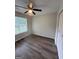 Bedroom featuring hardwood floors, a ceiling fan, a window, and closet space at 60 Doe Run Dr, Sharpsburg, GA 30277