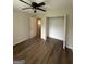 Spacious bedroom with new floors, a ceiling fan, closet, and an entry door at 60 Doe Run Dr, Sharpsburg, GA 30277