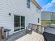 Wooden deck, perfect for outdoor dining, with a sliding door entrance into the home and a grill at 520 Pemberton St, Euharlee, GA 30145