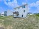 View of the home's back exterior and deck overlooking a well-maintained lawn and open space at 520 Pemberton St, Euharlee, GA 30145