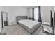 Cozy bedroom features neutral tones, a tufted headboard bed frame, and ample natural light at 520 Pemberton St, Euharlee, GA 30145