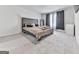 Comfortable bedroom boasts a large bed, neutral decor, plush carpet, and natural light at 520 Pemberton St, Euharlee, GA 30145