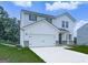 Beautiful two-story home with white siding, two-car garage, and well-maintained lawn at 520 Pemberton St, Euharlee, GA 30145