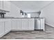 Modern kitchen features white cabinets, stainless steel appliances, and granite countertops at 520 Pemberton St, Euharlee, GA 30145