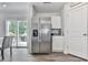 Contemporary kitchen showcasing stainless steel refrigerator, granite counters, and ample cabinet space at 520 Pemberton St, Euharlee, GA 30145