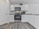 Well-equipped kitchen featuring modern appliances, granite countertops, and stylish cabinetry at 520 Pemberton St, Euharlee, GA 30145
