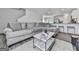 Cozy living room featuring a plush gray sofa, marble coffee table, and open floor plan at 520 Pemberton St, Euharlee, GA 30145