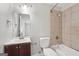 Bathroom with tiled shower, white toilet, and dark vanity at 7335 Connell Rd, Fairburn, GA 30213