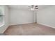 Neutral bedroom with carpet, ceiling fan, and view through the window at 7335 Connell Rd, Fairburn, GA 30213