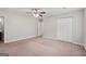 Bedroom with neutral walls, carpet, ceiling fan, closet, and ensuite bathroom at 7335 Connell Rd, Fairburn, GA 30213