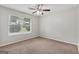 Bedroom featuring neutral paint, plush carpet, and a window offering natural light at 7335 Connell Rd, Fairburn, GA 30213