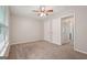 A bedroom features a closet, carpet, and natural light at 7335 Connell Rd, Fairburn, GA 30213