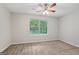 Bedroom with tan carpet, a ceiling fan, and a window at 7335 Connell Rd, Fairburn, GA 30213
