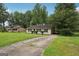 Well-kept single-story home with a long driveway and spacious front yard, offering plenty of parking at 7335 Connell Rd, Fairburn, GA 30213