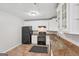 The kitchen is equipped with white cabinets, granite countertops, and black appliances at 7335 Connell Rd, Fairburn, GA 30213