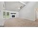Spacious living room featuring vaulted ceilings, a cozy fireplace, and double doors leading to the outdoors at 7335 Connell Rd, Fairburn, GA 30213