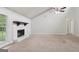 Cozy living room with a vaulted ceiling, a ceiling fan, and a charming fireplace, creating a warm ambiance at 7335 Connell Rd, Fairburn, GA 30213
