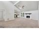 Inviting living room with an open layout, showcasing a fireplace, vaulted ceilings, and seamless flow to the kitchen at 7335 Connell Rd, Fairburn, GA 30213