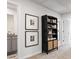 Hallway with modern decor, featuring a stylish bookshelf and adjacent bathroom at 11569 Kimberly Way, Hampton, GA 30228
