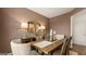 Cozy dining room featuring a rustic wood table, neutral chairs, and warm, inviting ambiance at 143 Oakchase Park Ln, Hampton, GA 30228