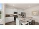 Modern kitchen with white cabinets, granite countertops, stainless steel appliances, and a breakfast bar at 143 Oakchase Park Ln, Hampton, GA 30228